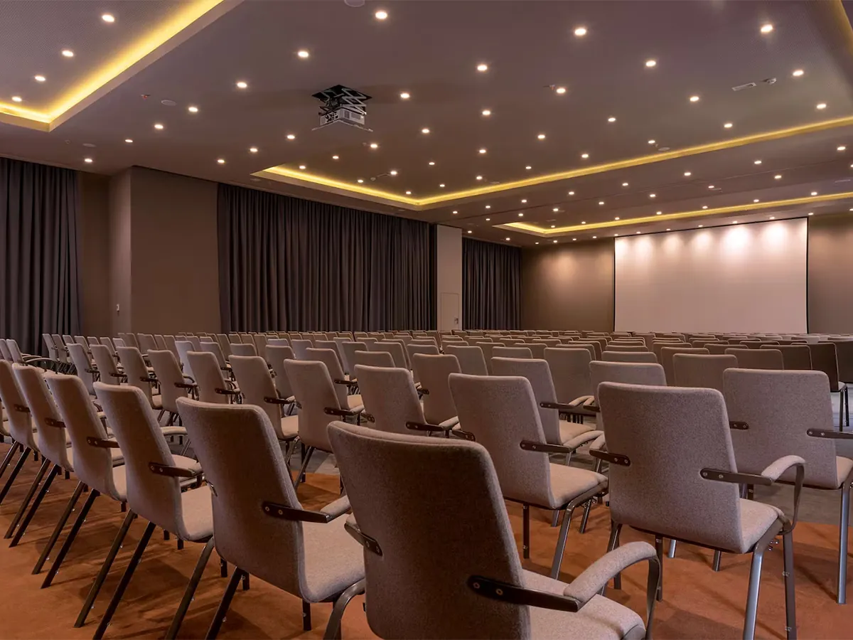 Stage with a speaker presenting to an audience
